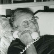Max M. Fisher at home, performing on what an interviewer described as his "favorite instrument," the telephone.