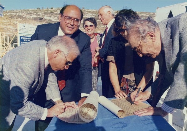 Charles Shusterman and Max M. Fisher add their signatures to the scroll that was placed in the cornerstone of the Academy.