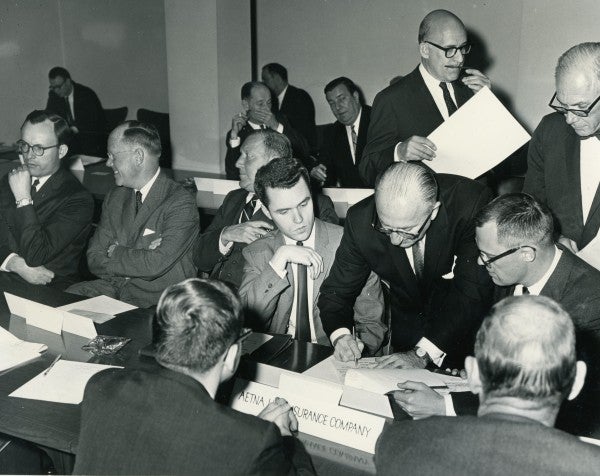 Signing papers during a meeting on the Jewish Agency for Israel loan agreement.