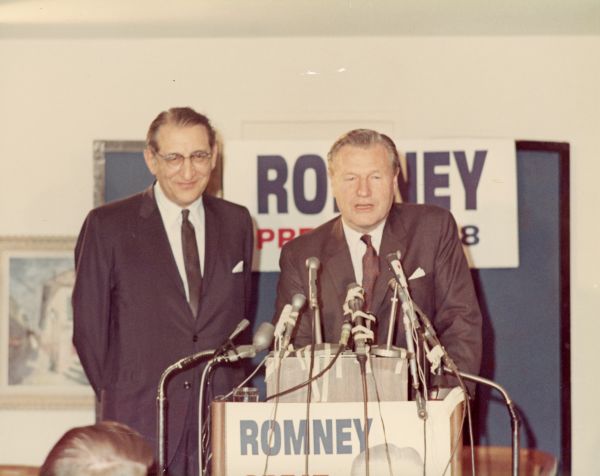 Max M. Fisher looks on as Nelson A. Rockefeller speaks at a presidential campaign fundraising event for George Romney in Detroit.
