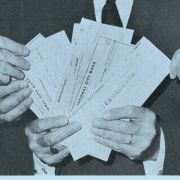 A blue pamphlet declares the United Jewish Appeal is guarantor in loan between 11 U.S. Life Insurance companies and Jewish Agency for Israel, Inc. and shows UJA executives Gottlieb Hammer, Max Fisher, Dewey Stone, and Rabbi Herbert Friedman displays checks worth $50 million.