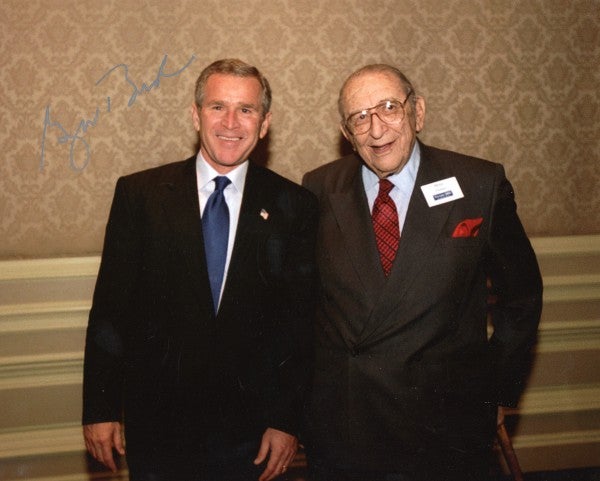 A photo of Max M. Fisher and President George W. Bush, signed by the President.