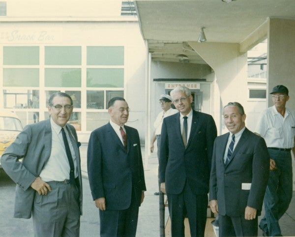Max M. Fisher, Howard H. West, Harold L. Kennedy and Vernon Stouffer outside of Butler Aviation Terminal, National Airport.