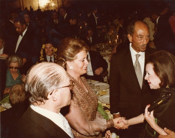 Marjorie Fisher shakes hands with Jihan Sadat, the wife of Eyptian President Anwar Sadat.