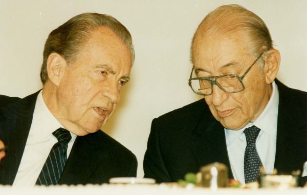 Max Fisher and Richard Nixon talking during a dinner reception for the former president.