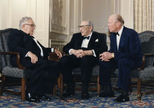 Max Fisher, Henry Kissinger, and Gerald Ford converse at Fisher's 90th birthday celebration.
