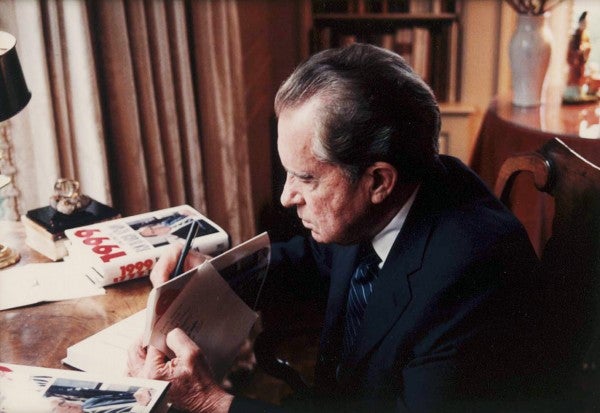 Nixon signs copies of his book, "1999: Victory Without War."