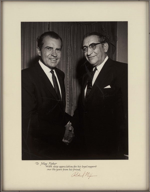 Max Fisher and Richard Nixon shaking hands.