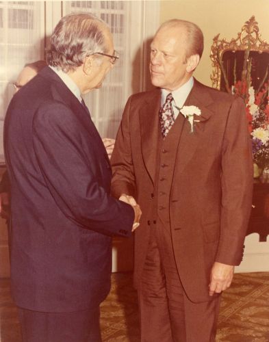 Max M. Fisher and President Gerald Ford greet each other.